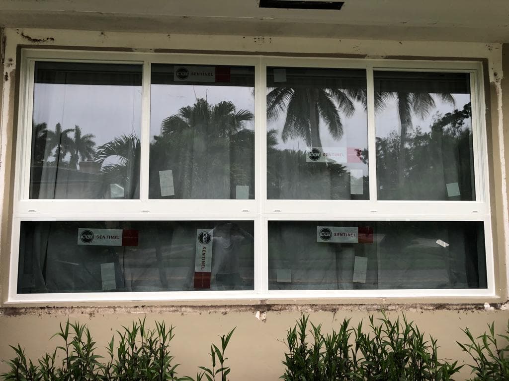 Hurricane impact rated garage door with window panels installed on a Florida home providing wind rated protection up to 175 mph