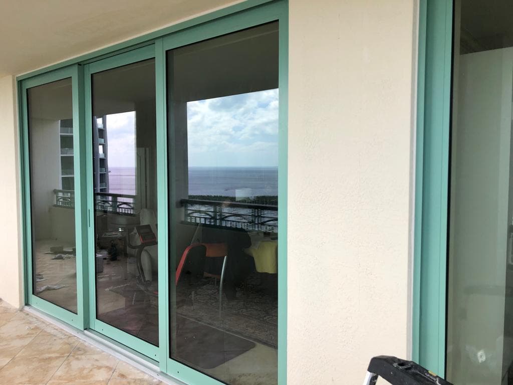 Hurricane protection impact windows installed on a home in Homestead Florida with large missile impact rated laminated glass