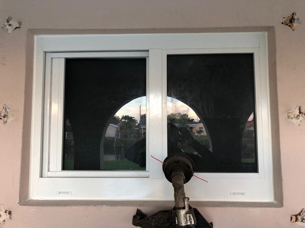 Impact resistant windows installed in a bedroom of a Miami Florida home with laminated glass providing storm protection and noise reduction