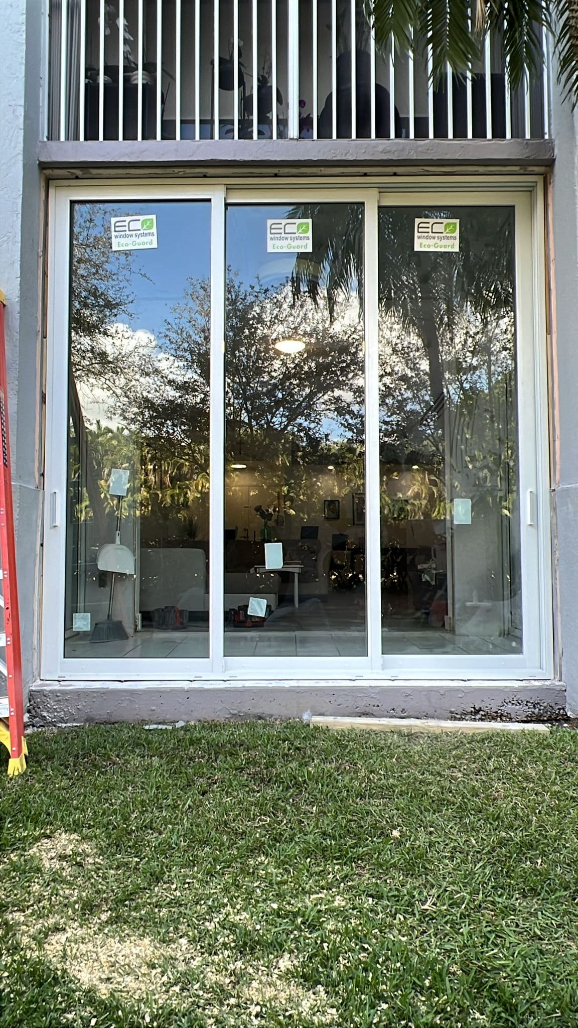 Close-up photo of installed impact window showing glass clarity and frame quality with laminated impact resistant glass