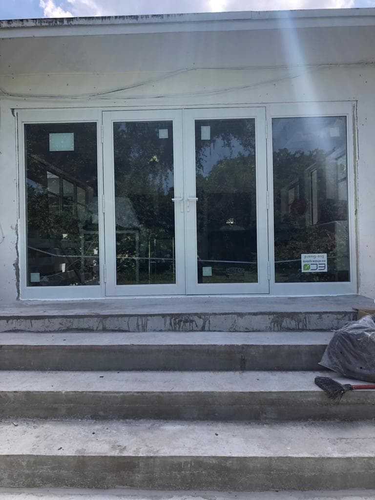 Real on-site measurement being taken for impact window installation at a Florida property with professional tools and technician