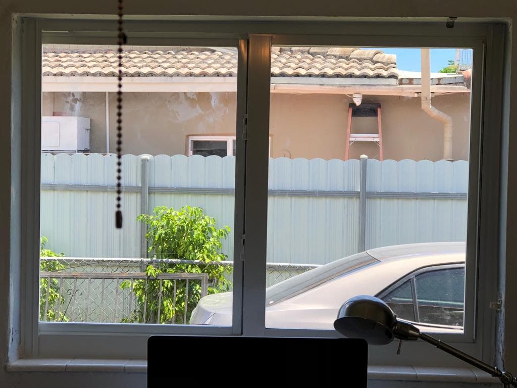 Completed impact window installation at a Florida property showing finished window with clean interior trim and exterior caulking
